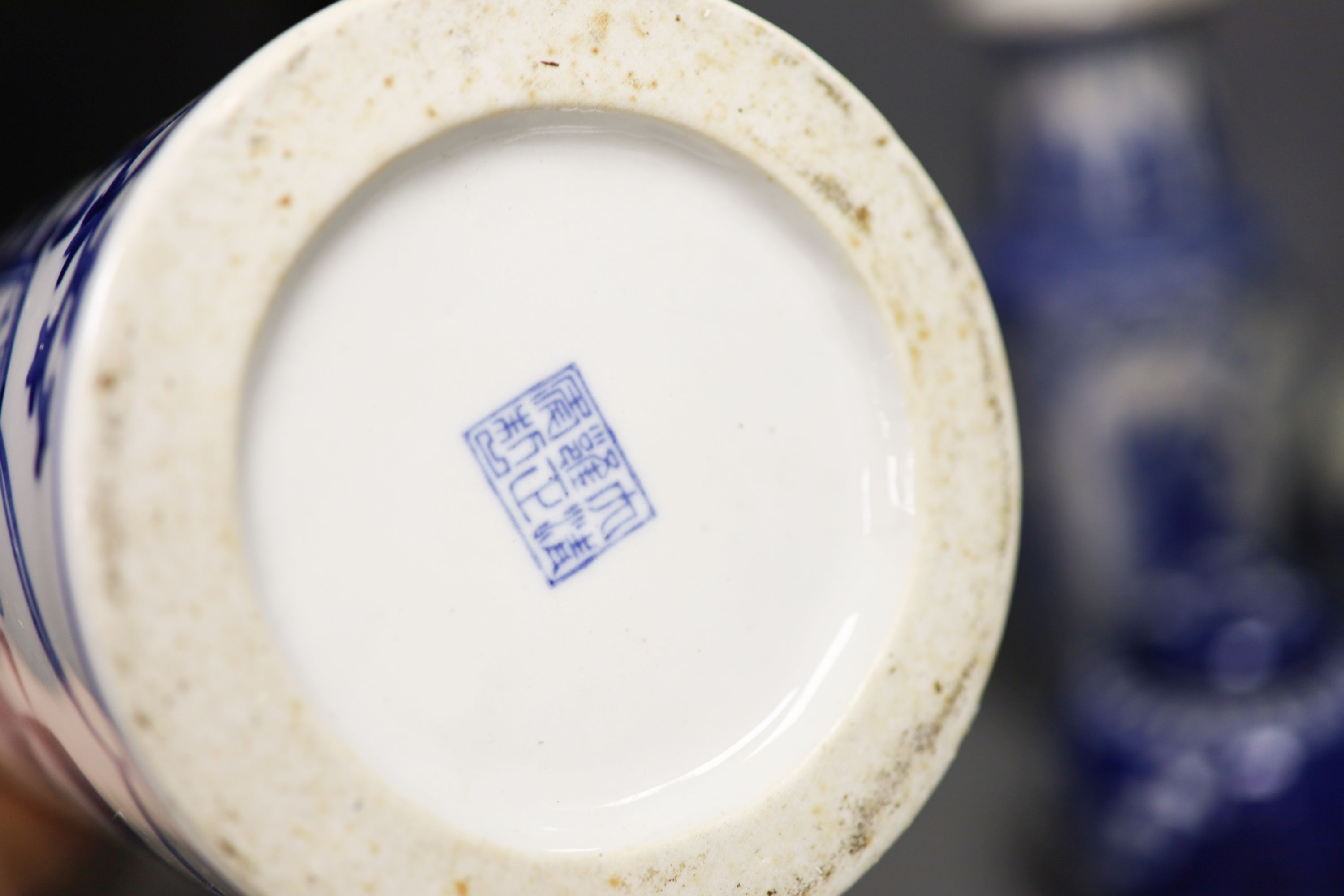 A group of seven Chinese blue and white porcelain vases and jars, 19th/20th century, and three wood stands 27cm